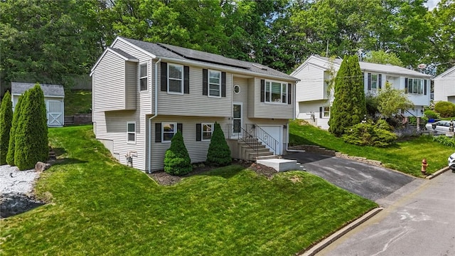 15 Lawnacre Dr, North Providence, RI 02911 - raised ranch with driveway, an attached garage, roof mounted solar panels, and a front yard