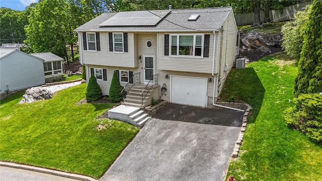 15 Lawnacre Dr, North Providence, RI 02911 - bi-level home with driveway, a garage, solar panels, central AC, and a front lawn