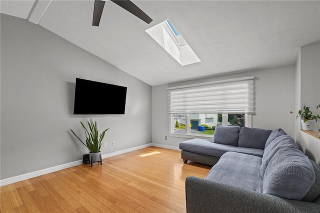 15 Lawnacre Dr, North Providence, RI 02911 - living room with a skylight, light wood finished floors, vaulted ceiling, ceiling fan, and baseboards