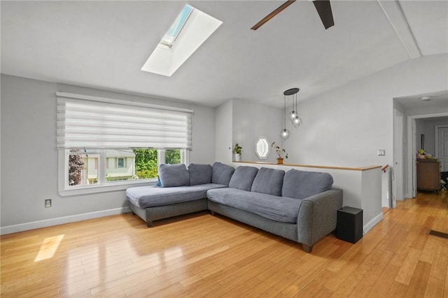 15 Lawnacre Dr, North Providence, RI 02911 - living room with lofted ceiling, light wood-type flooring, ceiling fan, a skylight, and baseboards