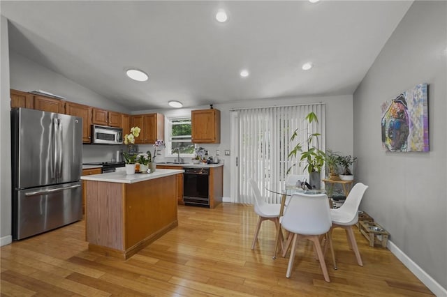 15 Lawnacre Dr, North Providence, RI 02911 - kitchen with black appliances, lofted ceiling, light countertops, light wood-style flooring, and a center island