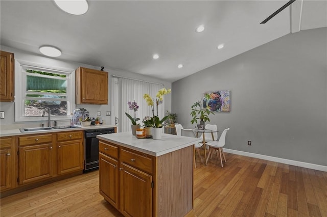 15 Lawnacre Dr, North Providence, RI 02911 - kitchen featuring a sink, black dishwasher, light wood-style floors, light countertops, and a center island