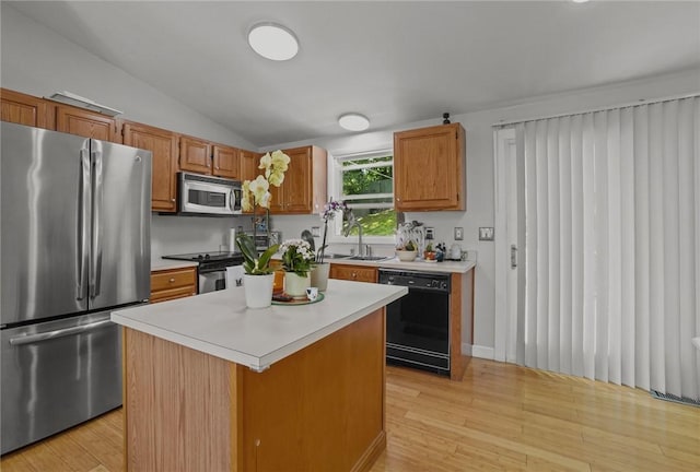 15 Lawnacre Dr, North Providence, RI 02911 - kitchen featuring appliances with stainless steel finishes, a sink, vaulted ceiling, light wood-style floors, and light countertops