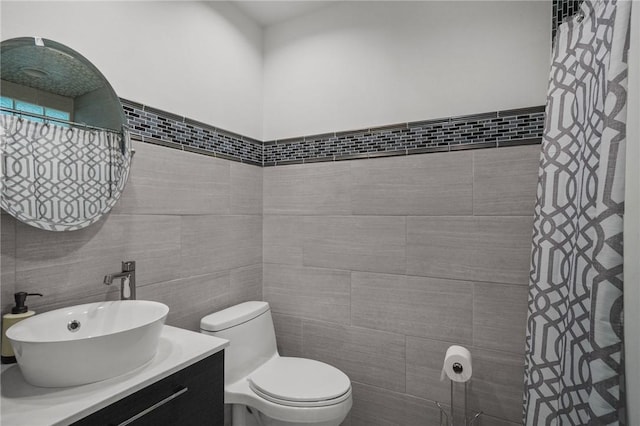 15 Lawnacre Dr, North Providence, RI 02911 - bathroom featuring vanity, toilet, curtained shower, and tile walls
