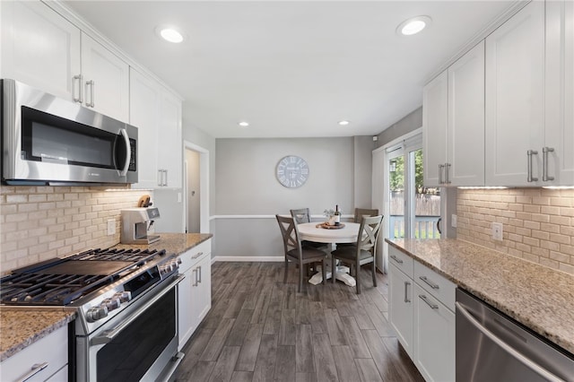 23 Revere St, Pawtucket, RI 02861 - kitchen featuring appliances with stainless steel finishes, dark wood finished floors, white cabinetry, backsplash, and recessed lighting