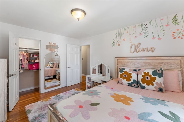 23 Revere St, Pawtucket, RI 02861 - bedroom with a walk in closet, wood finished floors, a closet, and baseboards