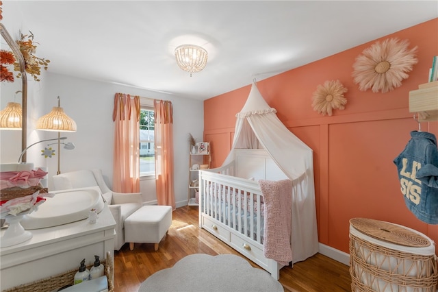 23 Revere St, Pawtucket, RI 02861 - bedroom with wood finished floors and a chandelier