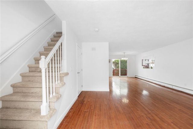 123 Forestwood Dr, North Providence, RI 02904 - staircase featuring a chandelier, wood-type flooring, and baseboards