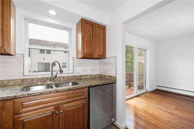 123 Forestwood Dr, North Providence, RI 02904 - kitchen with stainless steel dishwasher, a sink, brown cabinetry, stone countertops, and decorative backsplash