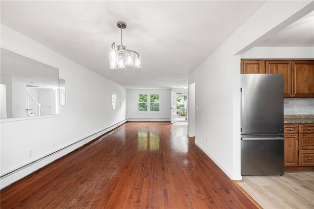123 Forestwood Dr, North Providence, RI 02904 - unfurnished dining area with hardwood / wood-style floors, a chandelier, baseboard heating, and baseboards