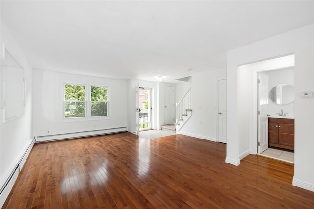 123 Forestwood Dr, North Providence, RI 02904 - unfurnished living room featuring hardwood / wood-style flooring, stairs, a baseboard heating unit, baseboard heating, and baseboards