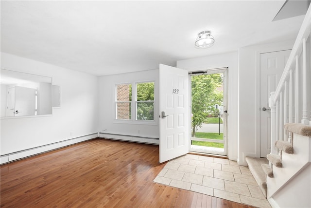 123 Forestwood Dr, North Providence, RI 02904 - foyer entrance with healthy amount of natural light, wood finished floors, stairs, and a baseboard heating unit