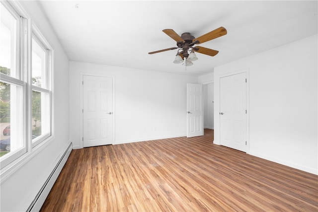 123 Forestwood Dr, North Providence, RI 02904 - empty room featuring a baseboard heating unit, light wood finished floors, a ceiling fan, and baseboards