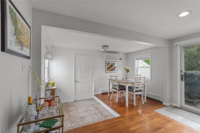 156 Davis Ave, Cranston, RI 02910 - dining room with a wall mounted air conditioner, baseboard heating, light wood-style flooring, and baseboards