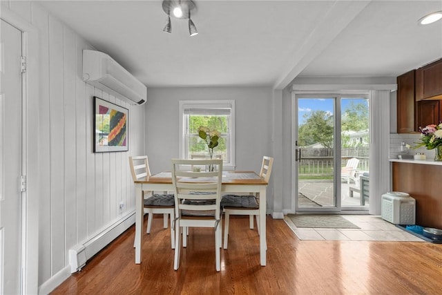 156 Davis Ave, Cranston, RI 02910 - dining space featuring baseboard heating, wood finished floors, a wall unit AC, and baseboards