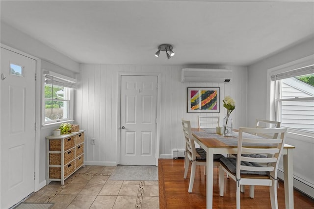 156 Davis Ave, Cranston, RI 02910 - dining area featuring a wall unit AC, plenty of natural light, and light tile patterned floors