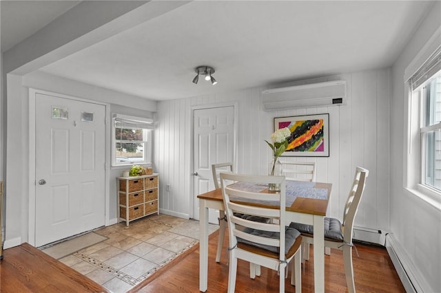 156 Davis Ave, Cranston, RI 02910 - dining space featuring a wall mounted AC, healthy amount of natural light, wood finished floors, and a baseboard radiator