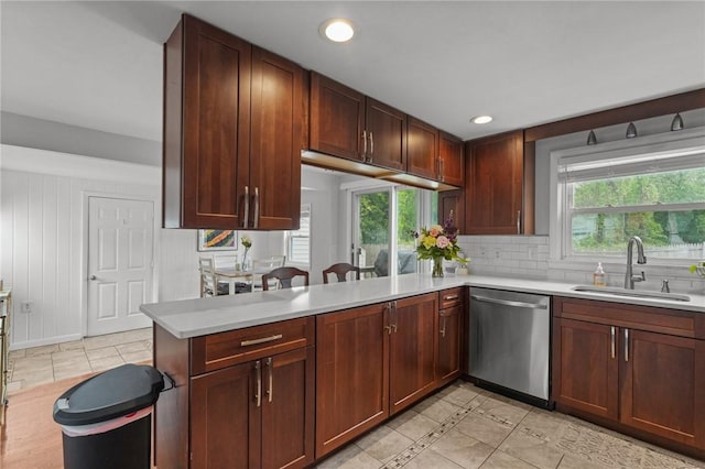 156 Davis Ave, Cranston, RI 02910 - kitchen featuring stainless steel dishwasher, a sink, light countertops, backsplash, and plenty of natural light