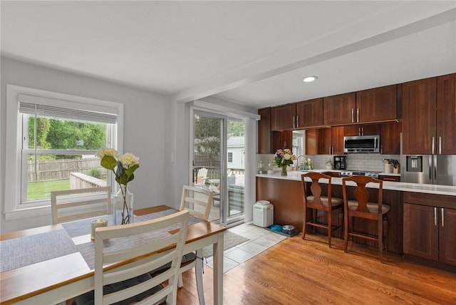 156 Davis Ave, Cranston, RI 02910 - kitchen featuring stainless steel microwave, light countertops, backsplash, plenty of natural light, and recessed lighting