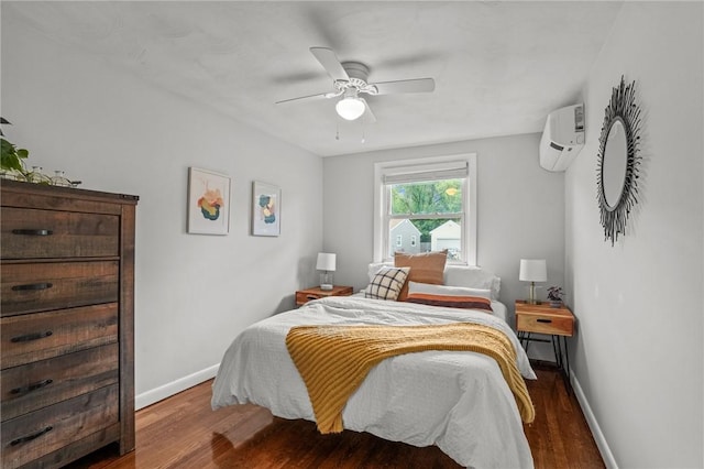 156 Davis Ave, Cranston, RI 02910 - bedroom featuring an AC wall unit, wood finished floors, baseboards, and ceiling fan