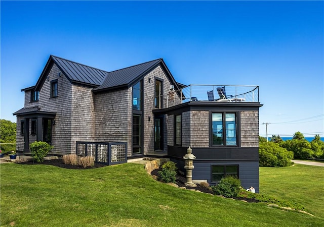 1448 Mohegan Trl, Block Island, RI 02807 - view of home's exterior with a standing seam roof, a yard, metal roof, and a balcony