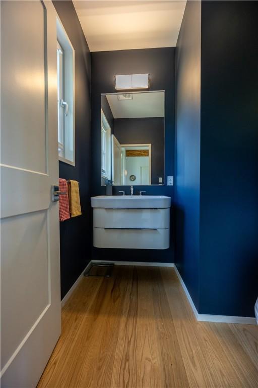 1448 Mohegan Trl, Block Island, RI 02807 - bathroom with wood finished floors, baseboards, vanity, and toilet