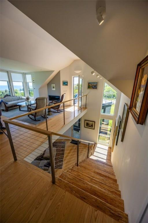 1448 Mohegan Trl, Block Island, RI 02807 - stairs featuring wood finished floors and vaulted ceiling