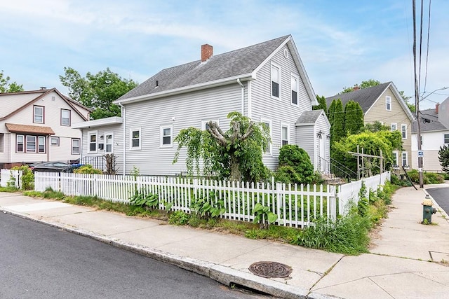 85 Herschel St, Providence, RI 02909 - view of home's exterior with a chimney and a fenced front yard