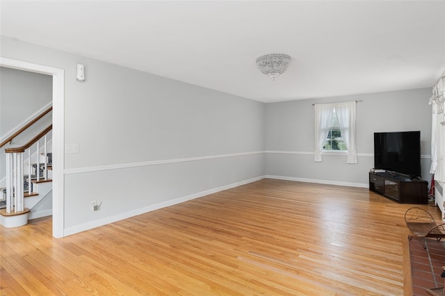 15 Metcalf Dr, Cumberland, RI 02864 - unfurnished living room featuring stairway and light wood-style floors