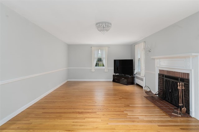 15 Metcalf Dr, Cumberland, RI 02864 - unfurnished living room with radiator, light wood-style floors, and a fireplace