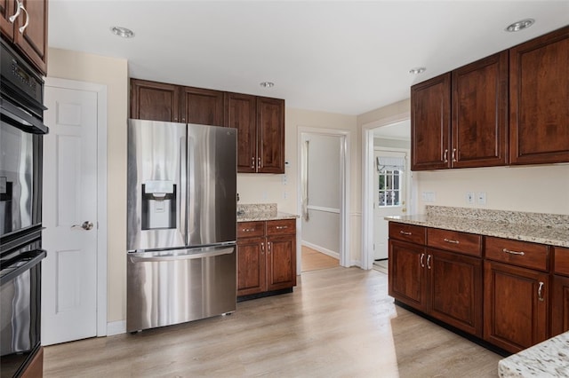 15 Metcalf Dr, Cumberland, RI 02864 - kitchen with stainless steel fridge, light wood-style flooring, light stone countertops, oven, and recessed lighting