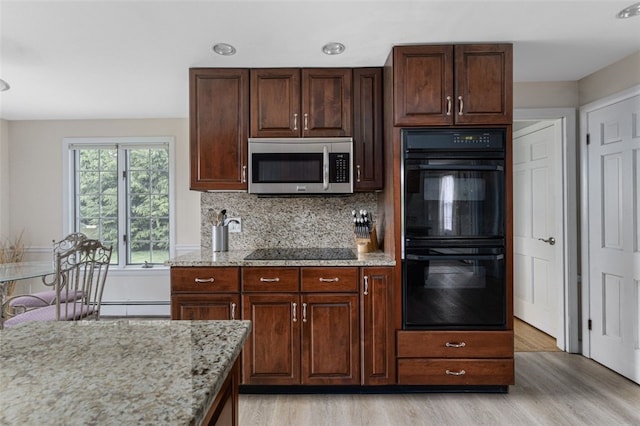 15 Metcalf Dr, Cumberland, RI 02864 - kitchen with black appliances, light wood finished floors, light stone countertops, decorative backsplash, and dark brown cabinetry