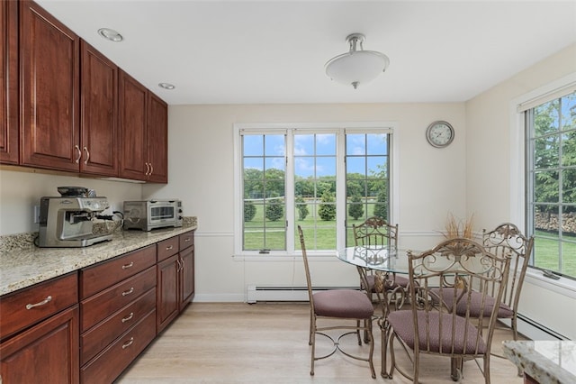 15 Metcalf Dr, Cumberland, RI 02864 - kitchen featuring light wood-style floors, light stone counters, and a baseboard radiator