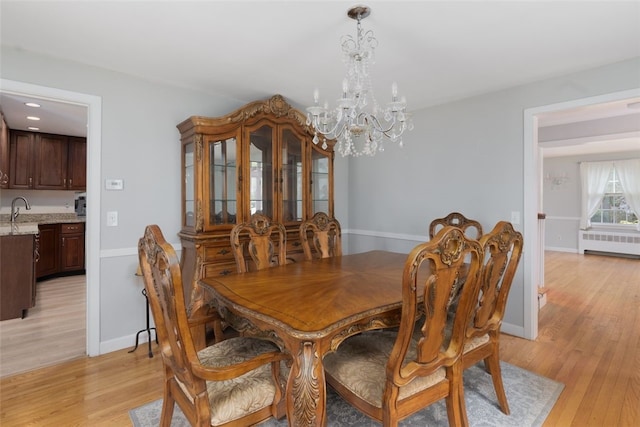 15 Metcalf Dr, Cumberland, RI 02864 - dining room with a chandelier, light wood-type flooring, and radiator