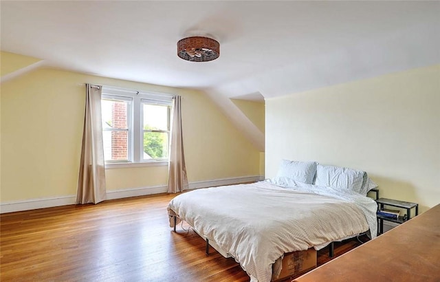 796 Pontiac Ave, Cranston, RI 02910 - bedroom with vaulted ceiling, wood finished floors, and baseboards