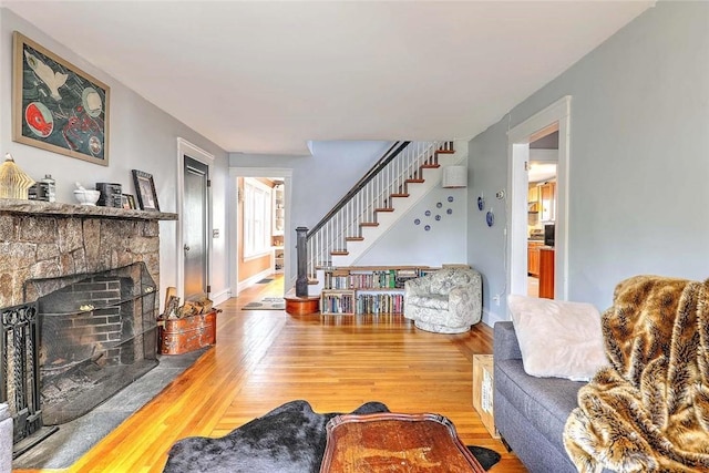 796 Pontiac Ave, Cranston, RI 02910 - living area with stairway, wood finished floors, and a stone fireplace