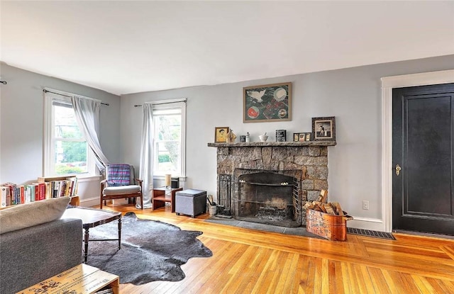 796 Pontiac Ave, Cranston, RI 02910 - living room featuring a fireplace, wood finished floors, and baseboards