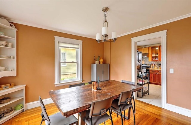 796 Pontiac Ave, Cranston, RI 02910 - dining area featuring a chandelier, baseboards, ornamental molding, and light wood finished floors