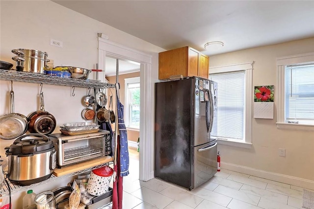 796 Pontiac Ave, Cranston, RI 02910 - kitchen with freestanding refrigerator, plenty of natural light, baseboards, and light tile patterned floors