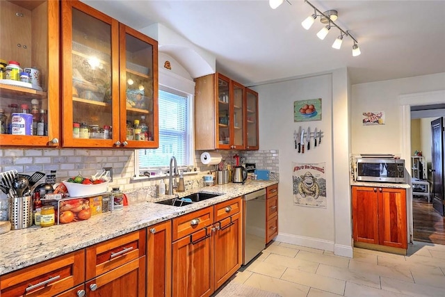 796 Pontiac Ave, Cranston, RI 02910 - kitchen with appliances with stainless steel finishes, a sink, backsplash, rail lighting, and light stone counters