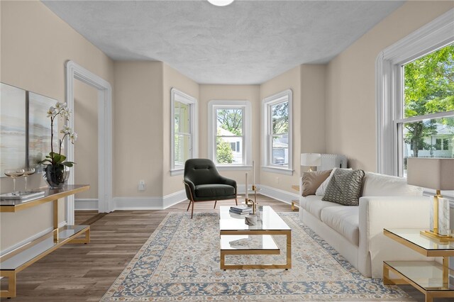62 Fenner Ave, East Providence, RI 02915 - living area with plenty of natural light, baseboards, and wood finished floors