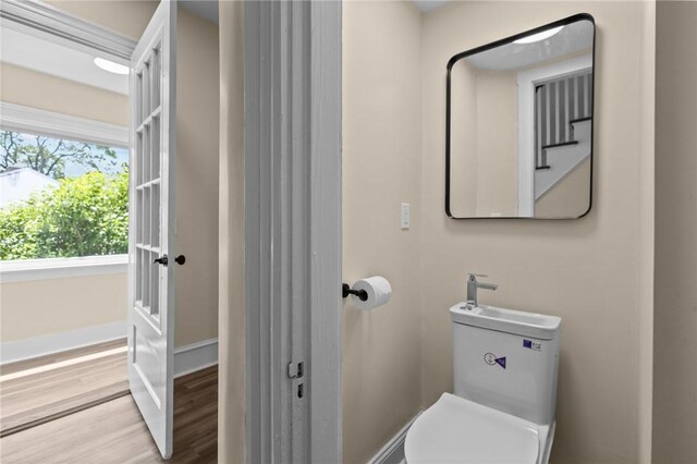 62 Fenner Ave, East Providence, RI 02915 - bathroom featuring wood finished floors, baseboards, and toilet