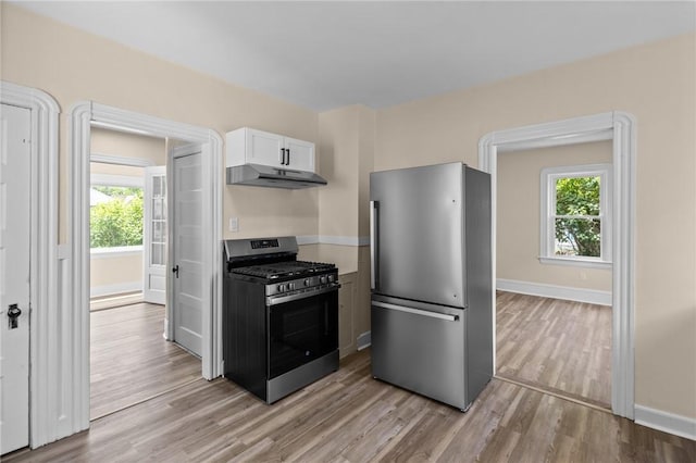 62 Fenner Ave, East Providence, RI 02915 - kitchen featuring appliances with stainless steel finishes, under cabinet range hood, light wood-style flooring, baseboards, and plenty of natural light