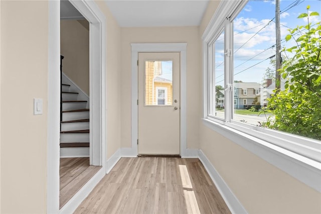 62 Fenner Ave, East Providence, RI 02915 - doorway featuring light wood-style flooring, baseboards, and stairway