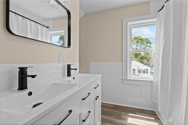 62 Fenner Ave, East Providence, RI 02915 - bathroom featuring vanity, tile walls, wood finished floors, and wainscoting