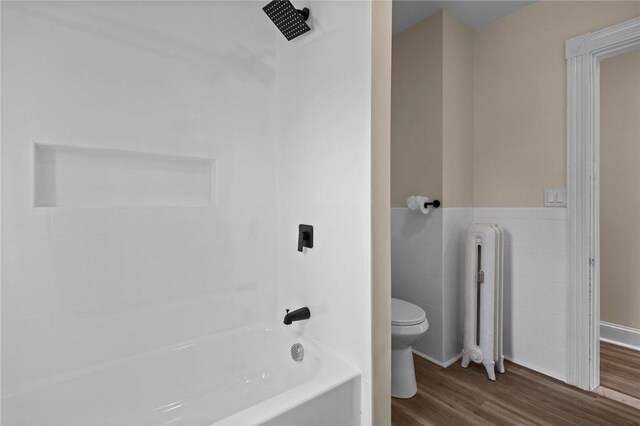 62 Fenner Ave, East Providence, RI 02915 - bathroom with radiator, toilet, wood finished floors, bathtub / shower combination, and tile walls