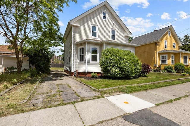 62 Fenner Ave, East Providence, RI 02915 - traditional-style home with a front lawn and asphalt driveway
