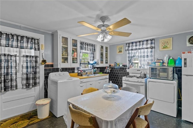 43 Dexter St, Woonsocket, RI 02895 - dining room with washer / clothes dryer, crown molding, a ceiling fan, and finished concrete floors