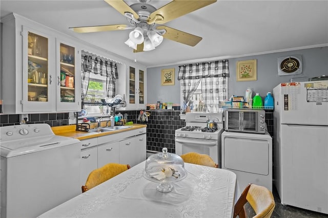 43 Dexter St, Woonsocket, RI 02895 - kitchen featuring washer / clothes dryer, white appliances, a sink, a ceiling fan, and crown molding