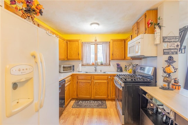 79 George Waterman Rd, Johnston, RI 02919 - kitchen featuring white appliances, a sink, light wood finished floors, light countertops, and brown cabinets